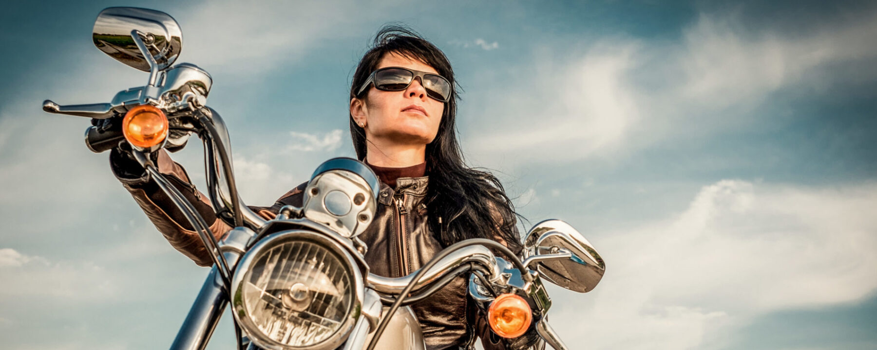 Woman on Motorcycle Looking up in direction she may travel