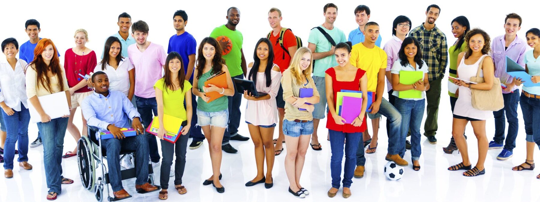 Many young people standing and sitting in a crowd